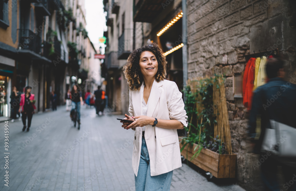 Trendy dressed travel blogger 20s exploring new city during getaway touristic vacations, Caucaisan hipster girl in stylish apparel using 4g wireless connecting on modern smartphone technology Trendy dressed travel blogger 20s exploring new city during getaway touristic vacations, Caucaisan hipster girl in stylish apparel using 4g wireless connecting on modern smartphone technology
