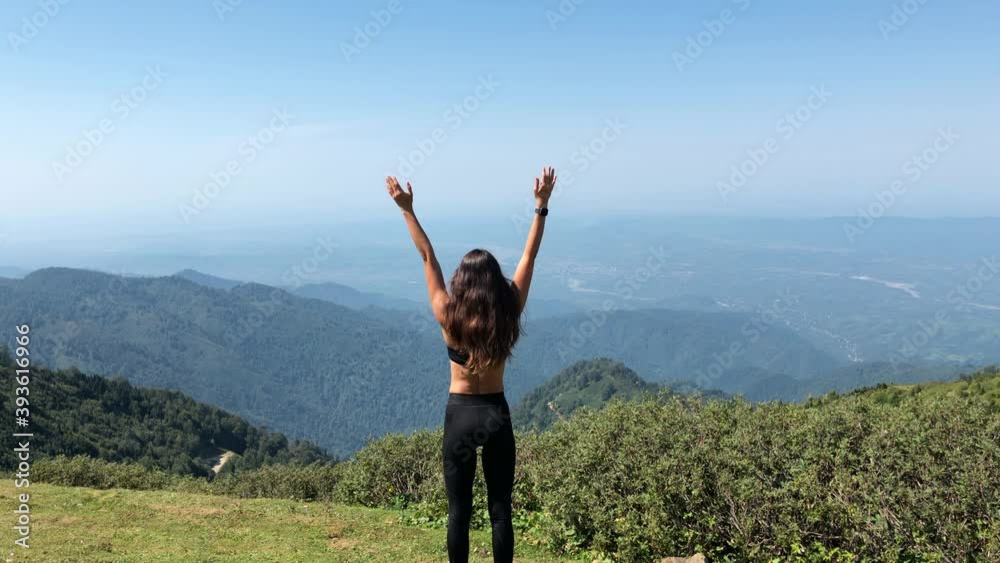 Woman Enjoying Mountain View. Female Standing on the Top of Hill Woman Enjoying Mountain View. Female Standing on the Top of Hill