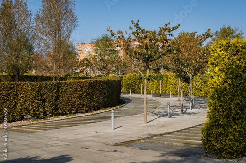 Wallpaper Mural City Park Krasnodar. Artificial rushing river with granite banks. Evergreen hedge encloses recreation area. Public landscape "Galician Park" for recreation and walks. Sunny autumn day. October 2020 Torontodigital.ca