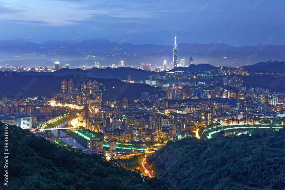 Aerial panorama of overpopulated suburban communities in Taipei at dusk with view of Taipei 101 Tower in downtown & bridges over Xindian River ~ A romantic evening of Taipei in beautiful blue twilight