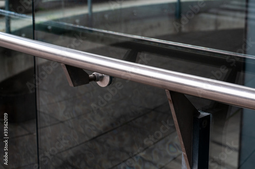 Photography a railing of stainless steel at a glass wall
