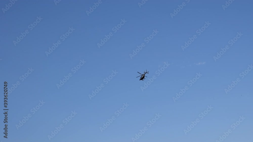 Helicopter Flying by over Forest in Blue Sky Trees, Clouds Helicopter Flying by over Forest in Blue Sky Trees, Clouds