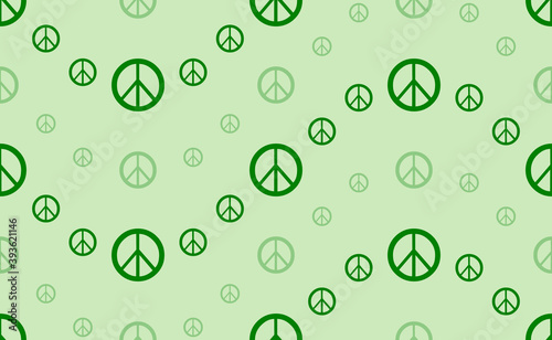Seamless pattern of large and small green peace symbols. The elements are arranged in a wavy. Vector illustration on light green background
