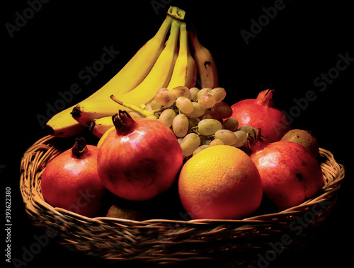 A bucket of fruits with black background