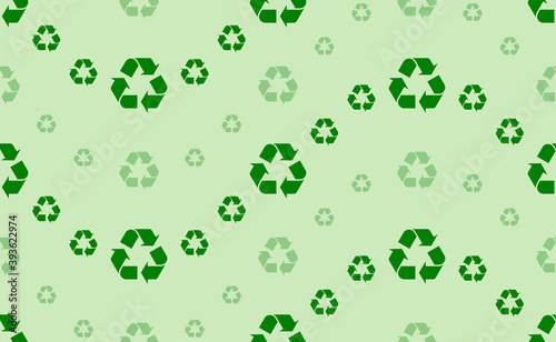 Seamless pattern of large and small green recycling symbols. The elements are arranged in a wavy. Vector illustration on light green background
