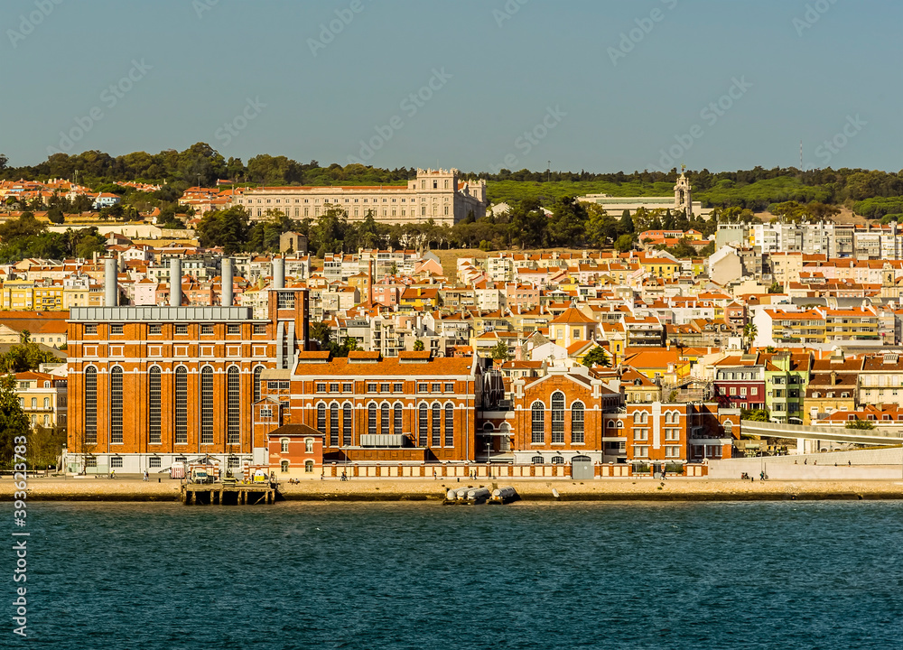 A view of colourful orange buildings on the shore of the river Tagus near Lisbon, Portugal