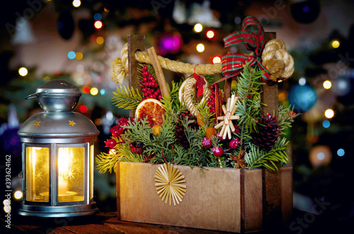 Festive New Year's still life of a flashlight and fir branches in a wooden box