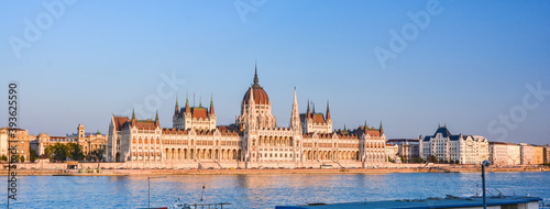 The Hungarian Parliament and the Danube river in Budapest, Hungary at sunset.