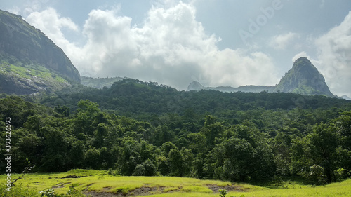 Panoramic view of lush green landscape with mountains near Devkund in Raigad, Maharashtra, India photo