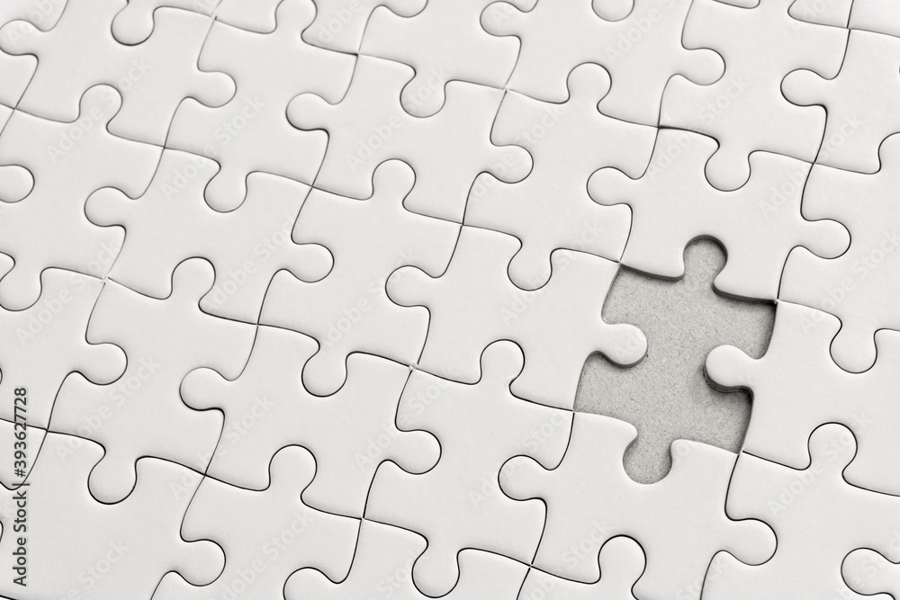 White jigsaw puzzle pattern background. placing last piece of jigsaw puzzle. White jigsaw puzzle pattern background. placing last piece of jigsaw puzzle.