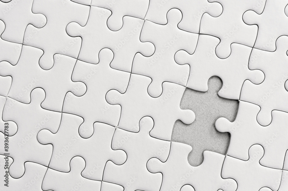 White jigsaw puzzle pattern background. placing last piece of jigsaw puzzle. White jigsaw puzzle pattern background. placing last piece of jigsaw puzzle.