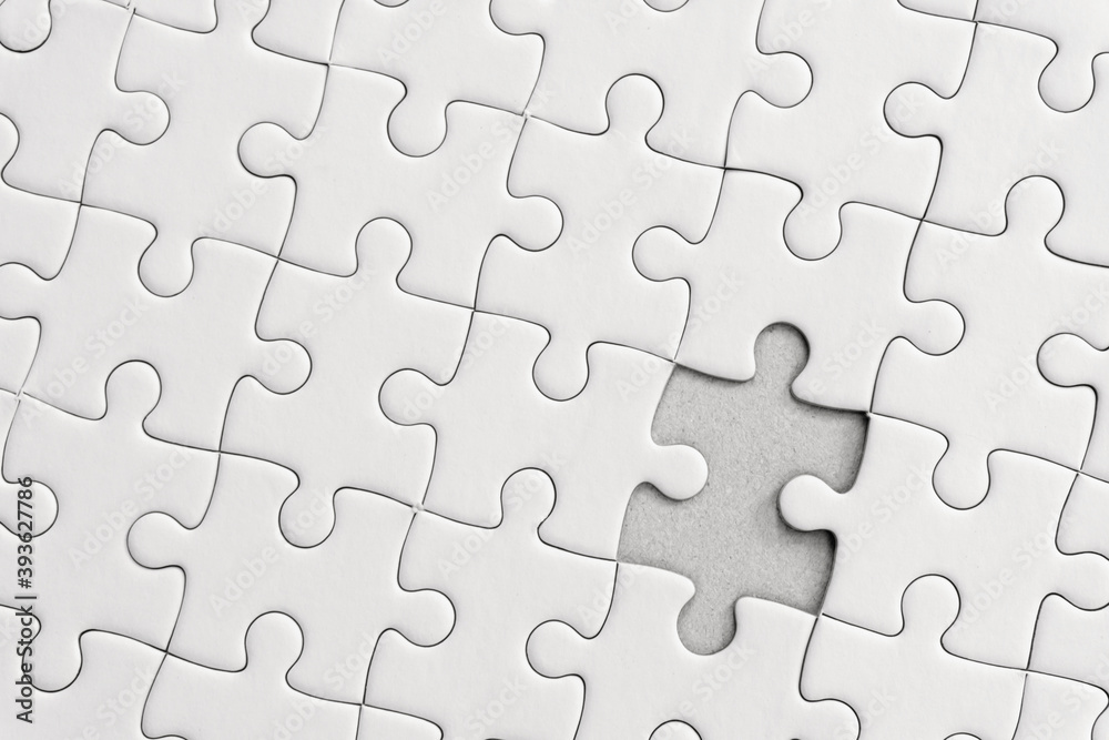 White jigsaw puzzle pattern background. placing last piece of jigsaw puzzle. White jigsaw puzzle pattern background. placing last piece of jigsaw puzzle.