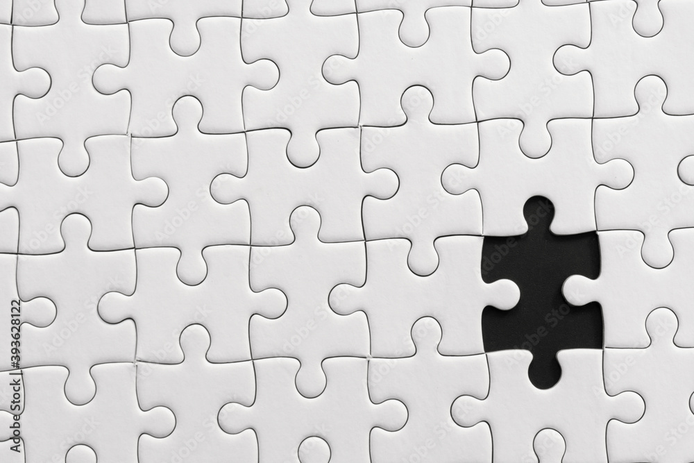 White jigsaw puzzle pattern background. placing last piece of jigsaw puzzle. White jigsaw puzzle pattern background. placing last piece of jigsaw puzzle.