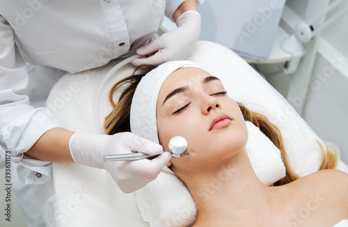 Woman getting face beauty treatment in medical spa center. photo