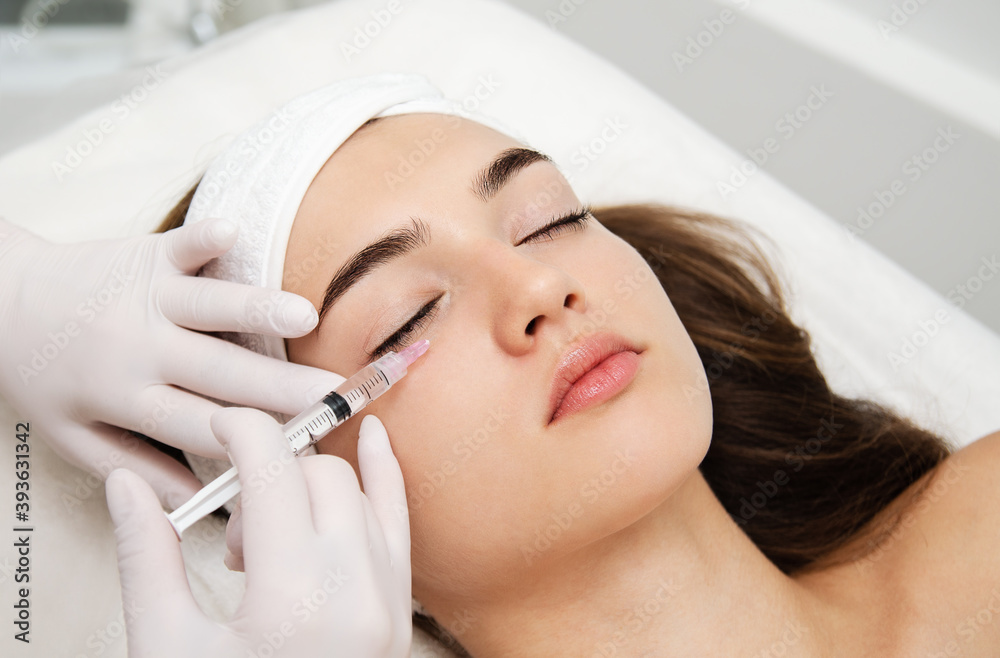 Woman getting cosmetic. injection. Beauty injections and cosmetology. Young woman in beauty salon sloseup. Woman getting cosmetic. injection. Beauty injections and cosmetology. Young woman in beauty salon sloseup.