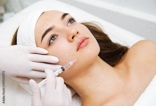 Woman getting cosmetic. injection. Beauty injections and cosmetology. Young  woman in beauty salon sloseup. Stock Photo