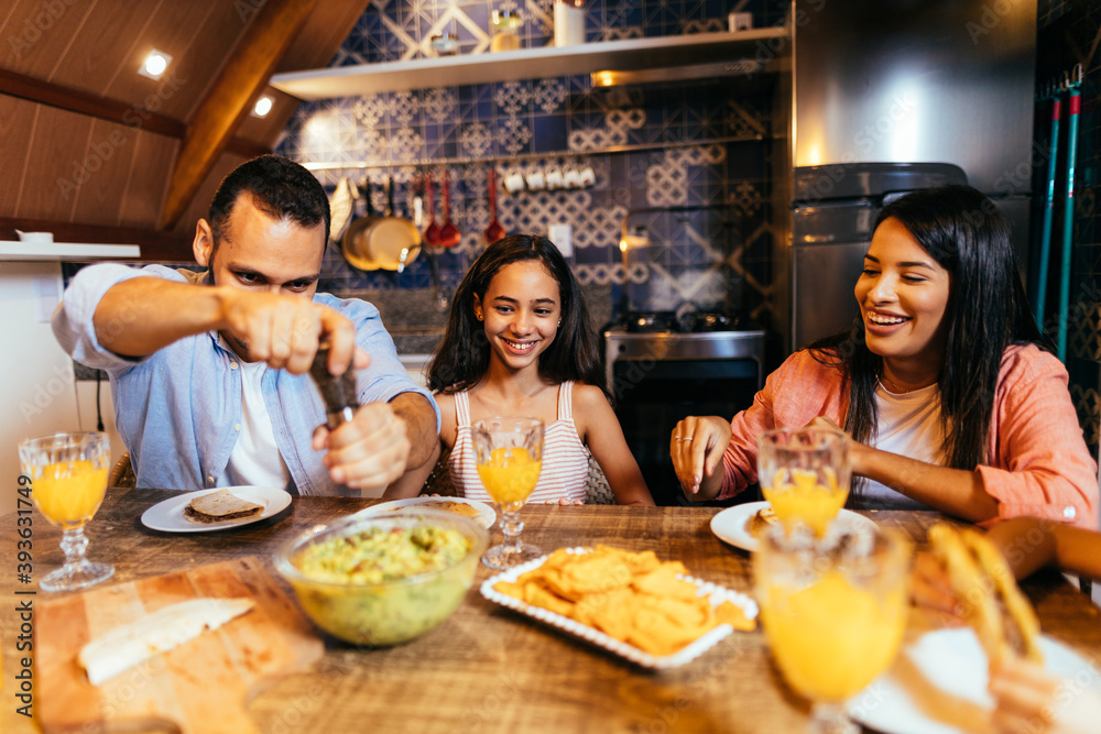 Latin family having dinner at home