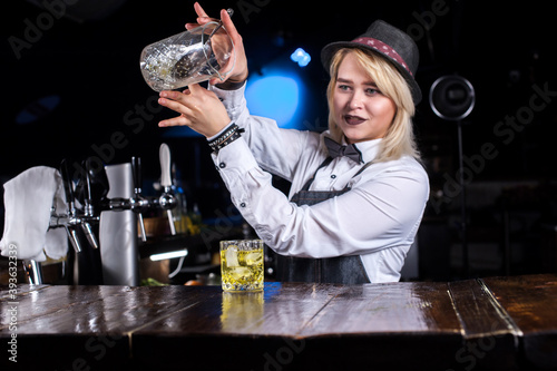 Girl bartender creates a cocktail on the brasserie photo