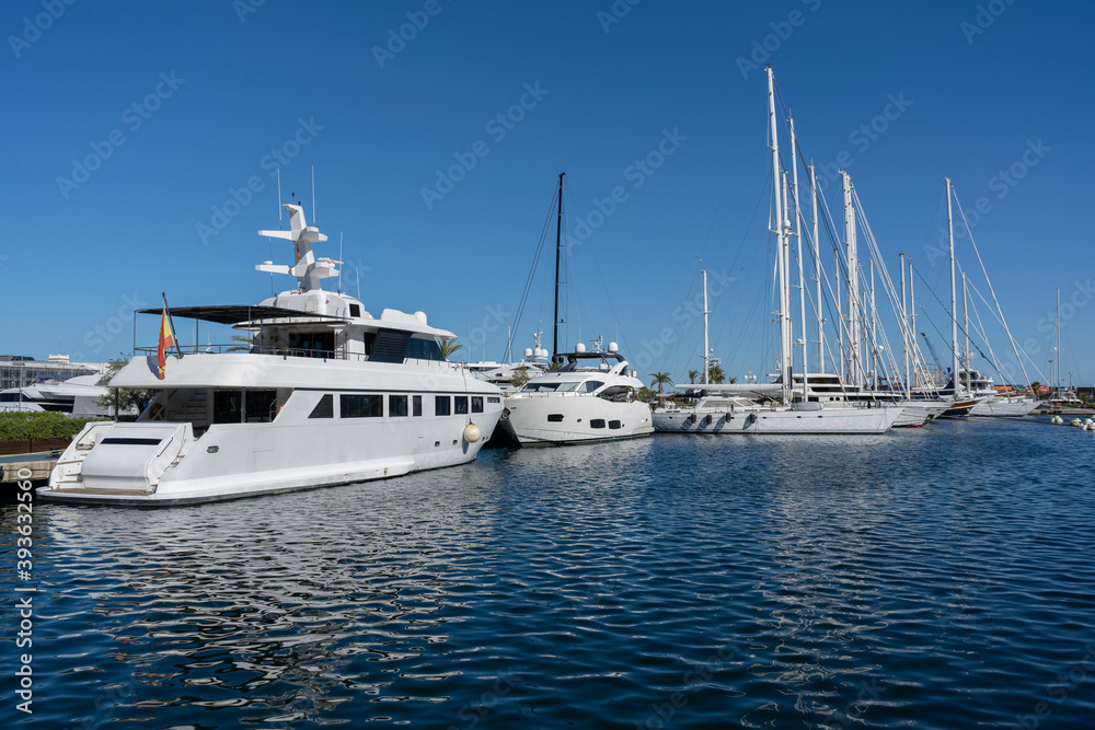 Luxury yachts and sailboats moored in docks in Marine port of Valencia.Concept of luxury , travel ,sail and summer background.