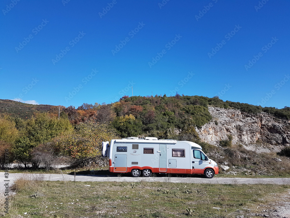 caravan car autumn in a forest sunny day