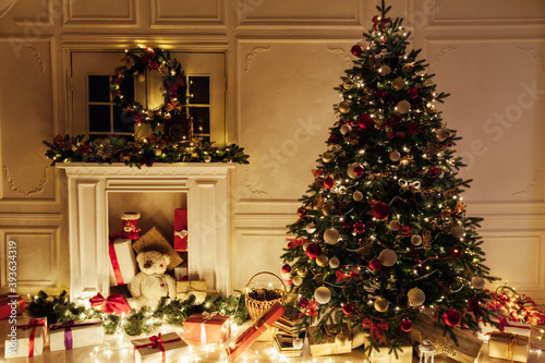 Christmas tree with gifts in the interer lights garland decor new year