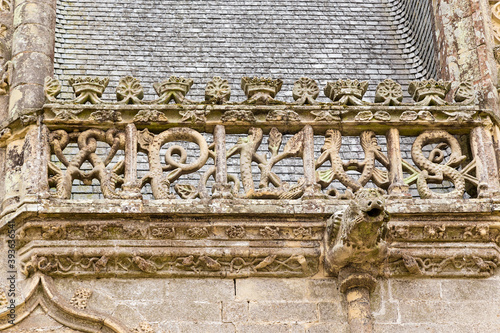 Josselin, France. Decorative stone carving on the castle facade and gargoyle photo