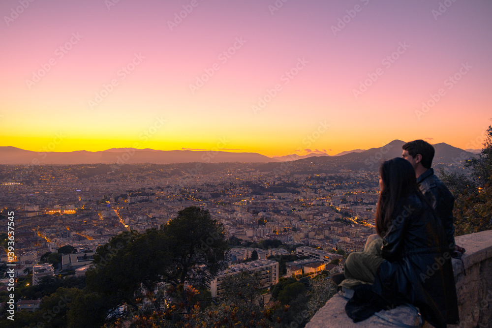 Menschen schauen auf die Stadt bei Sonnenuntergang