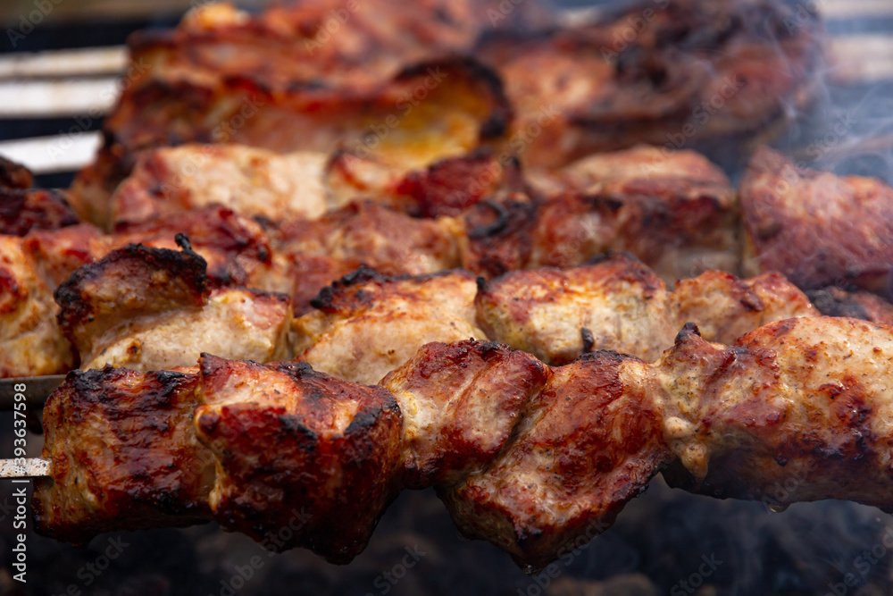 aromatic fresh grilled meat skewered on a grill in the fresh air