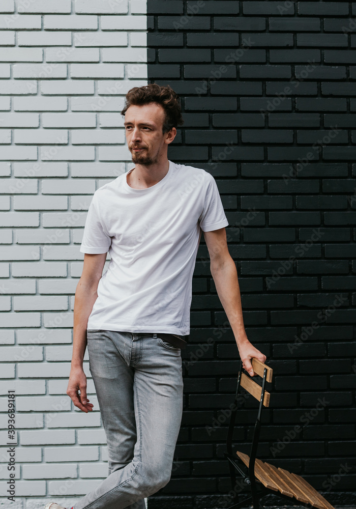 Young bearded hipster guy wearing white blank t-shirt. Mock-up for print. T-shirt template. Young bearded hipster guy wearing white blank t-shirt. Mock-up for print. T-shirt template.