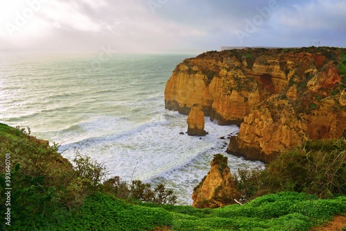 view on a foggy day of Ponta da Piedade, a spectacular rocky promontory along the coast of Lagos in the Algarve region. It is one of the most popular tourist attractions in Portugal