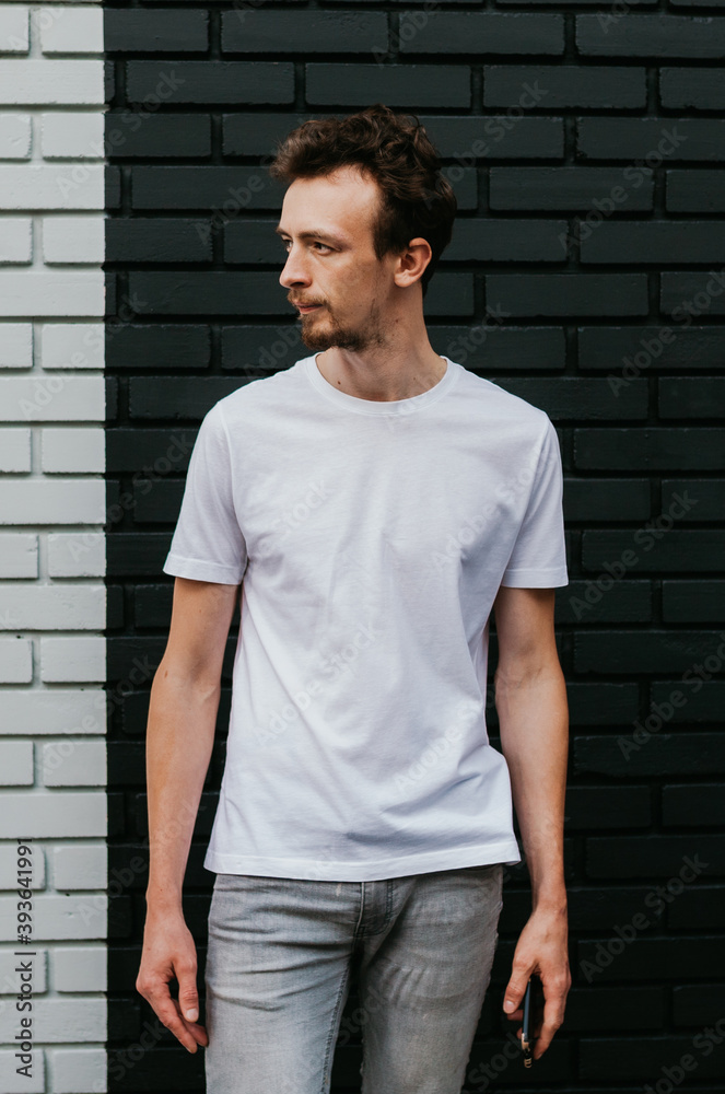 Young bearded hipster guy wearing white blank t-shirt. Mock-up for print. T-shirt template. Young bearded hipster guy wearing white blank t-shirt. Mock-up for print. T-shirt template.