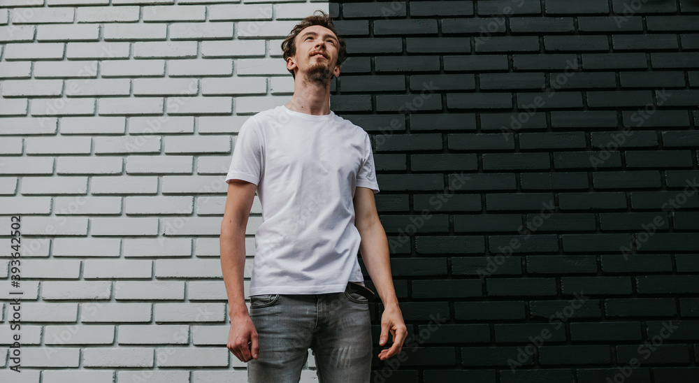 Young bearded hipster guy wearing white blank t-shirt. Mock-up for print. T-shirt template.