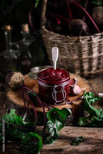 Homemade beet ketchup in a glass jar. Rustic style