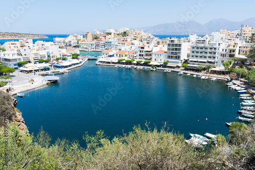 Agios Nikolaos. Crete. Buildings on the shore of Voulismeni Lake and boats at the pier