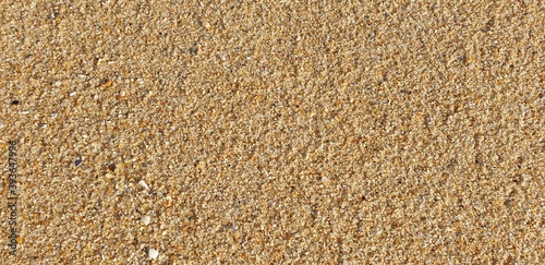 Detail of surface texture with small pebble rock and sand background.