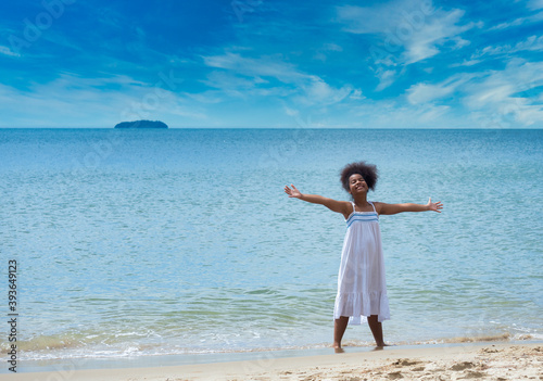 Portrait of African Asian ten years old girl enjoying on the beach on a summer day.