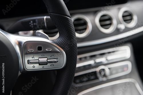 audio control buttons on the steering wheel of the car at shallow depth of field © phantom1311