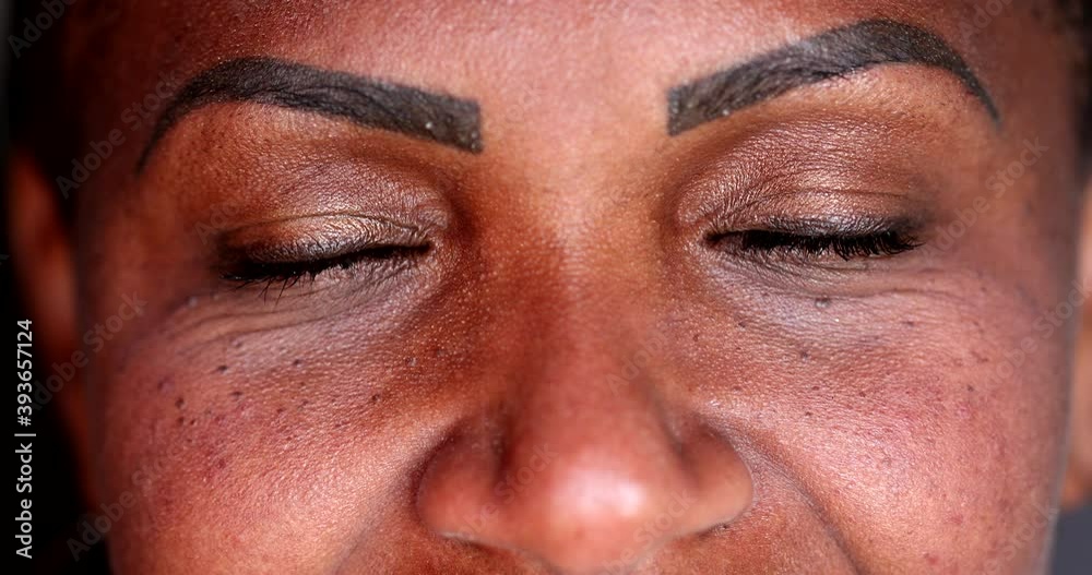 Black African woman closing eyes 40s Black African woman closing eyes 40s
