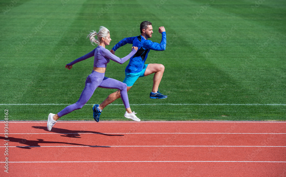 Fototapeta premium athletic couple of sprinters run on running track at stadium, energy