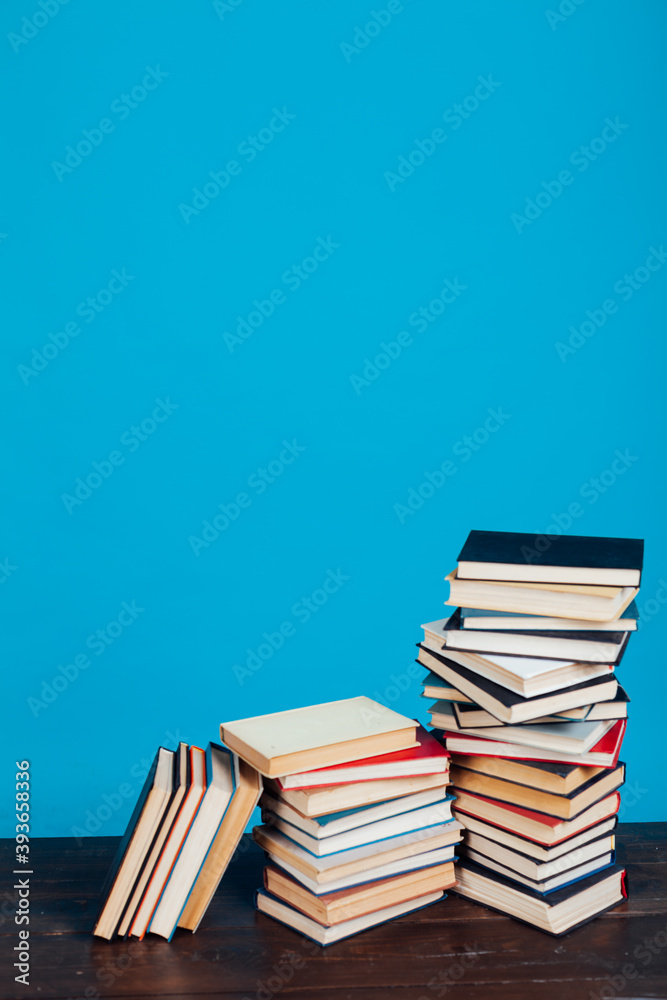 stacks of books for education in the college library on a blue background place for inscription stacks of books for education in the college library on a blue background place for inscription