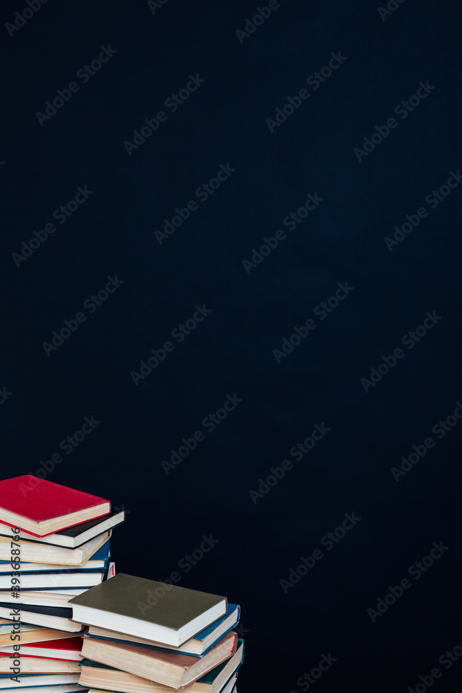 stacks of books for education in the library on a black background place for inscription stacks of books for education in the library on a black background place for inscription
