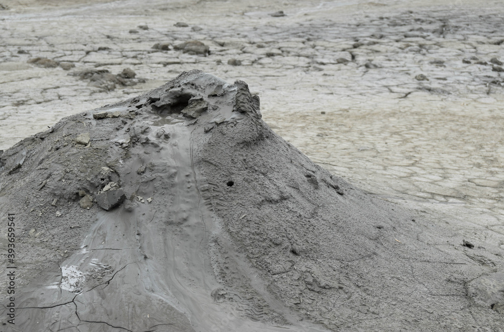 Mud liquid flowing from mud volcano, at Paclele Mari mud volcanoes in