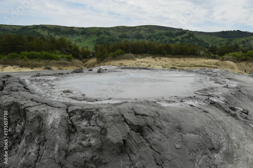 Bubbling crater of a mud volcano. Close up view onto gas bubble exploding in crater of mud volcano. Mud volcano at Paclele Mari, near Buzau, Romania.