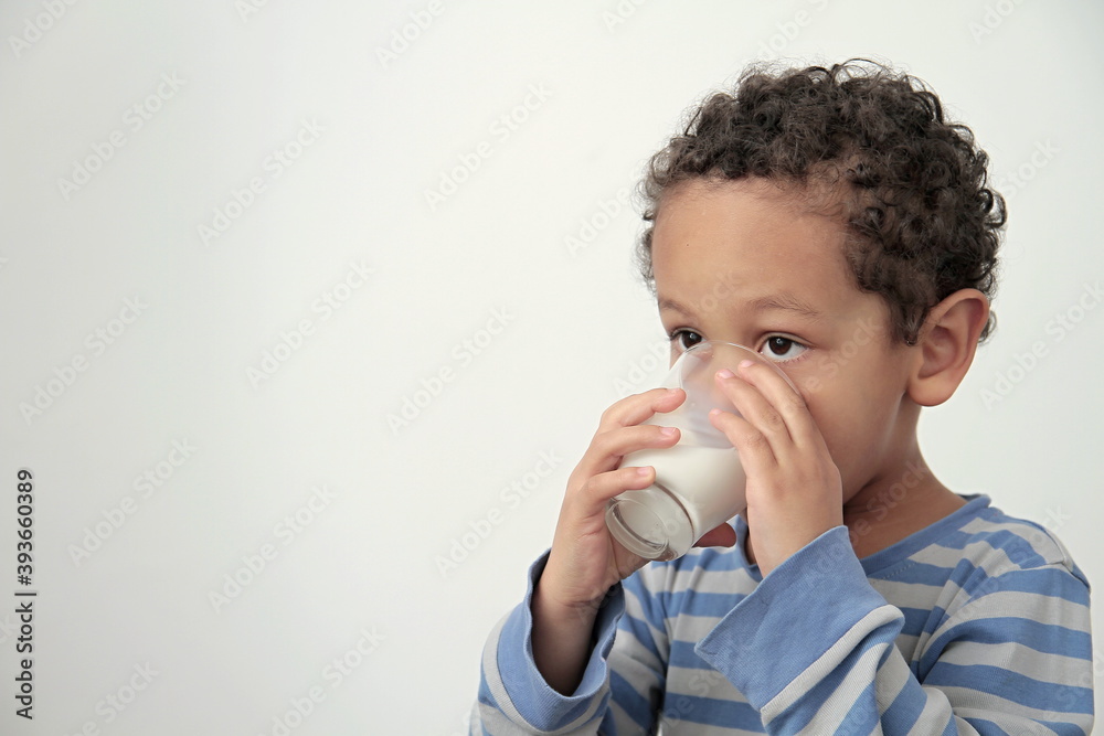 boy drinking milk for breakfast on white background stock photo boy drinking milk for breakfast on white background stock photo