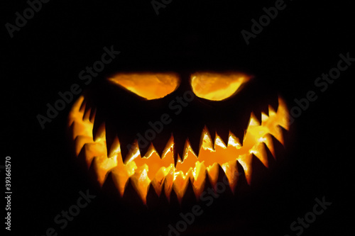 Halloween pumpkin glowing face in the dark.
