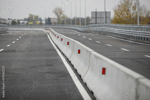 Shallow depth of field (selective focus) image with concrete Jersey barriers (Jersey walls or Jersey bumps) on a highway. photo