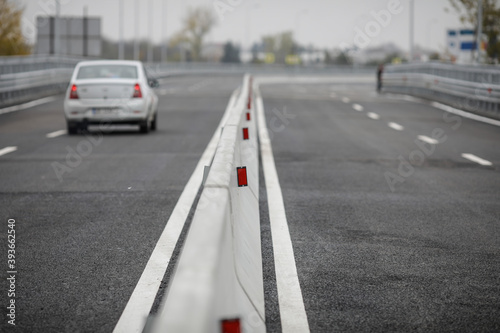 Shallow depth of field (selective focus) image with concrete Jersey barriers (Jersey walls or Jersey bumps) on a highway. © MoiraM