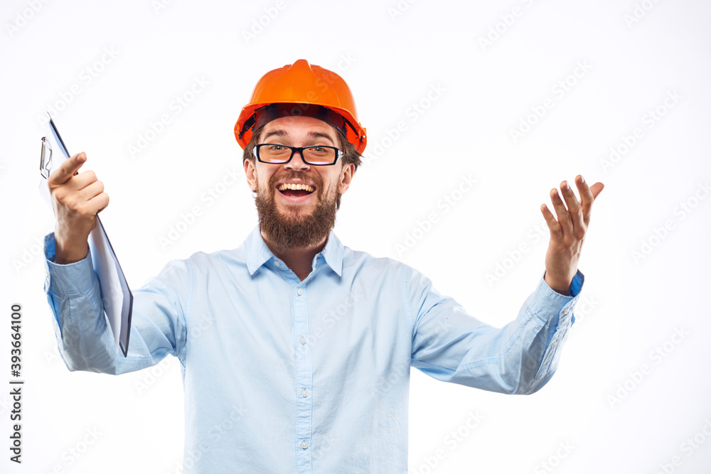 Cheerful man in orange hard hat construction documents service professionals Cheerful man in orange hard hat construction documents service professionals