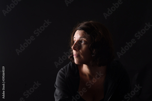  portrait of a woman look up on black background © curto