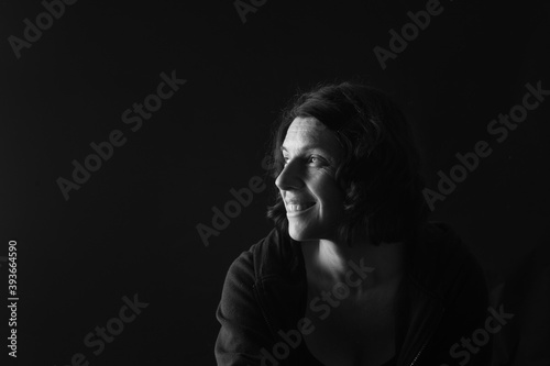 side view of a portrait of a woman on black background